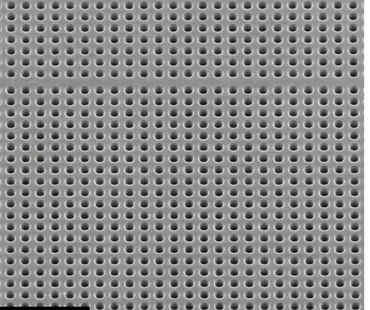 SEM micrograph of nanowell array - femtolitre-volume uniform wells in PMMA or COP, millions of wells per chip patterned by NIL